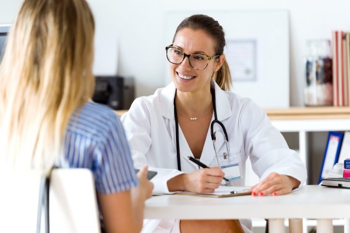 Female doctor explaining diagnosis to her patient.