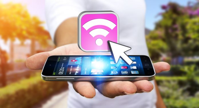 Young man using modern mobile to connect with wifi