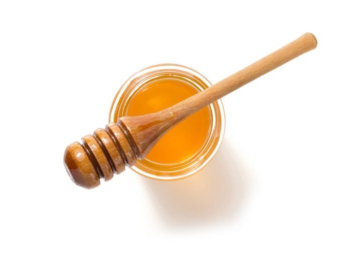 jar of honey on white background
