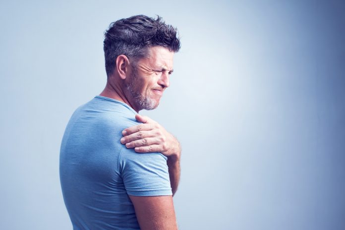People, healthcare and problem concept - unhappy man suffering from neck or shoulder pain at home