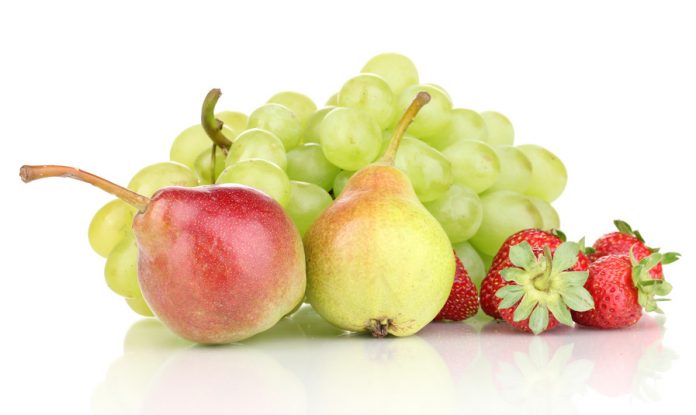 Mix of ripe sweet fruits and berries isolated on white