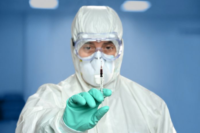 Scientist With Syringe containing Blood