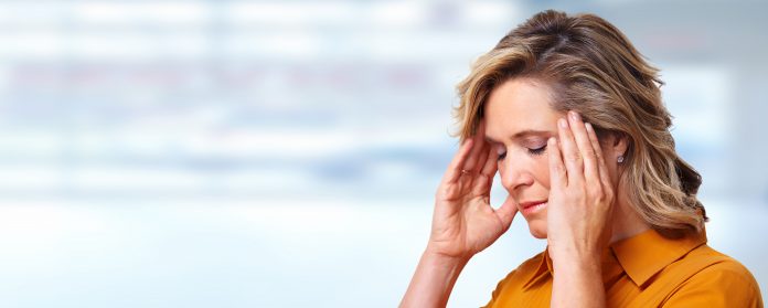 Woman having headache migraine.