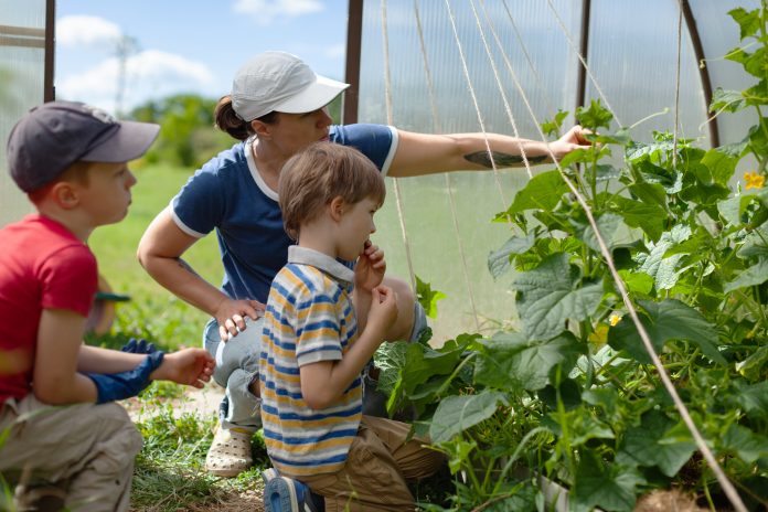 Woman and her children in garden