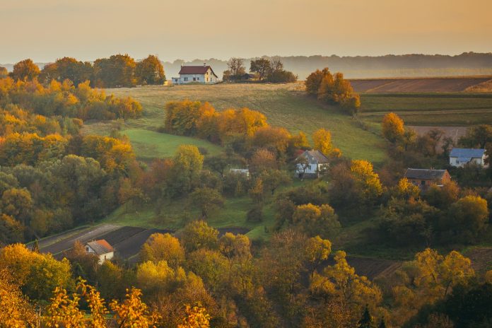 Beautiful autumn mountain landscape with houses at sunset