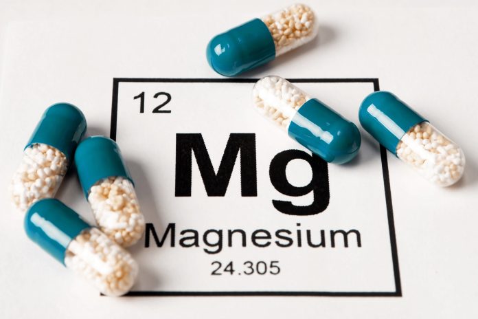 pills with mineral Mg (magnesium) on a white background with an inscription from the chemical table