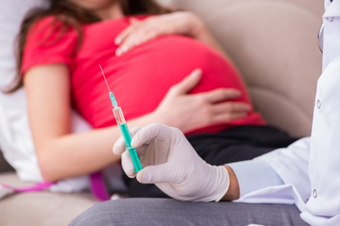 Pregnant woman patient visiting doctor for regular check-up