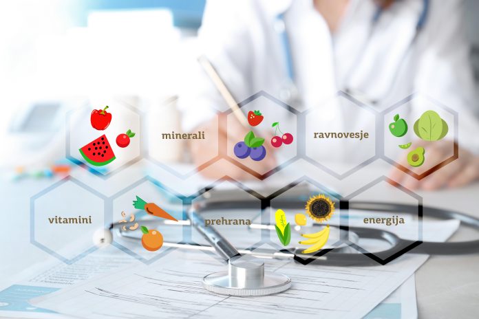 Nutritionist's recommendations. Doctor working at table in offic