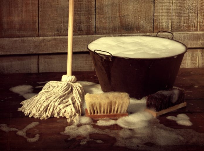 Cleaning mop and bucket with wet soapy floor
