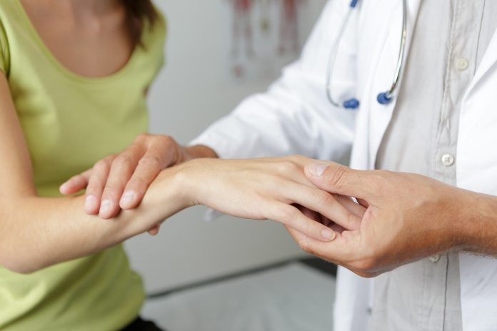 female hands showing carpal tunnel syndrome