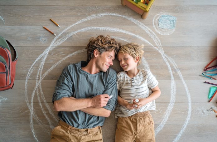 SV_MJ_overhead_view_of_a_parent_and_teenager_laying_on_a_floor Large