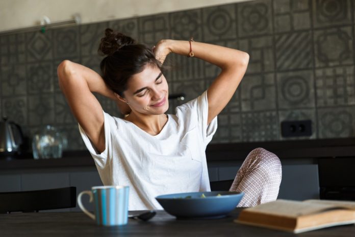 Attractive young woman having healthy breakfast