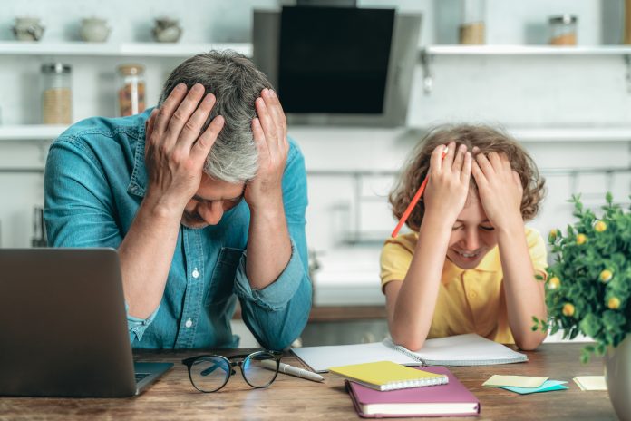 Confused father and son making school homework
