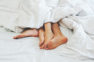 Young couple making sex under blanket in bedroom. Sleeping spouses in their bed. Happy family lifestyle. a family showdown ends in bed